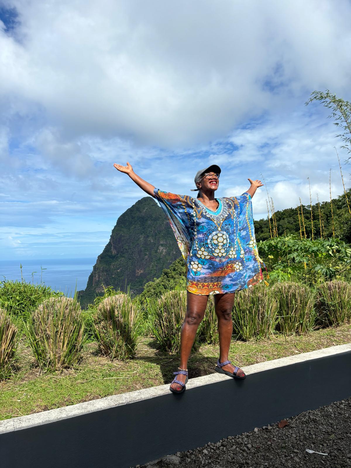 A wide-angle shot of a person standing at the edge of a cliff, overlooking a vast landscape A wide-angle shot of a person standing at the edge of a cliff, overlooking a vast landscape