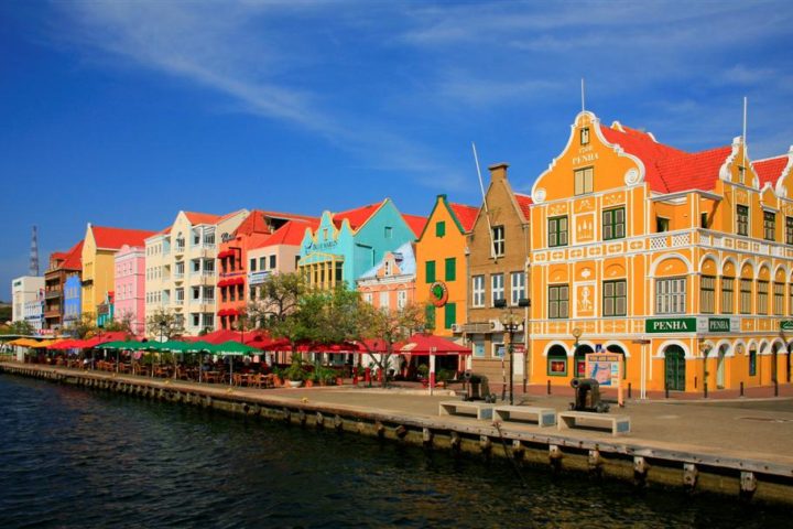 colorful Dutch colonial-style buildings along the waterfront colorful Dutch colonial-style buildings along the waterfront