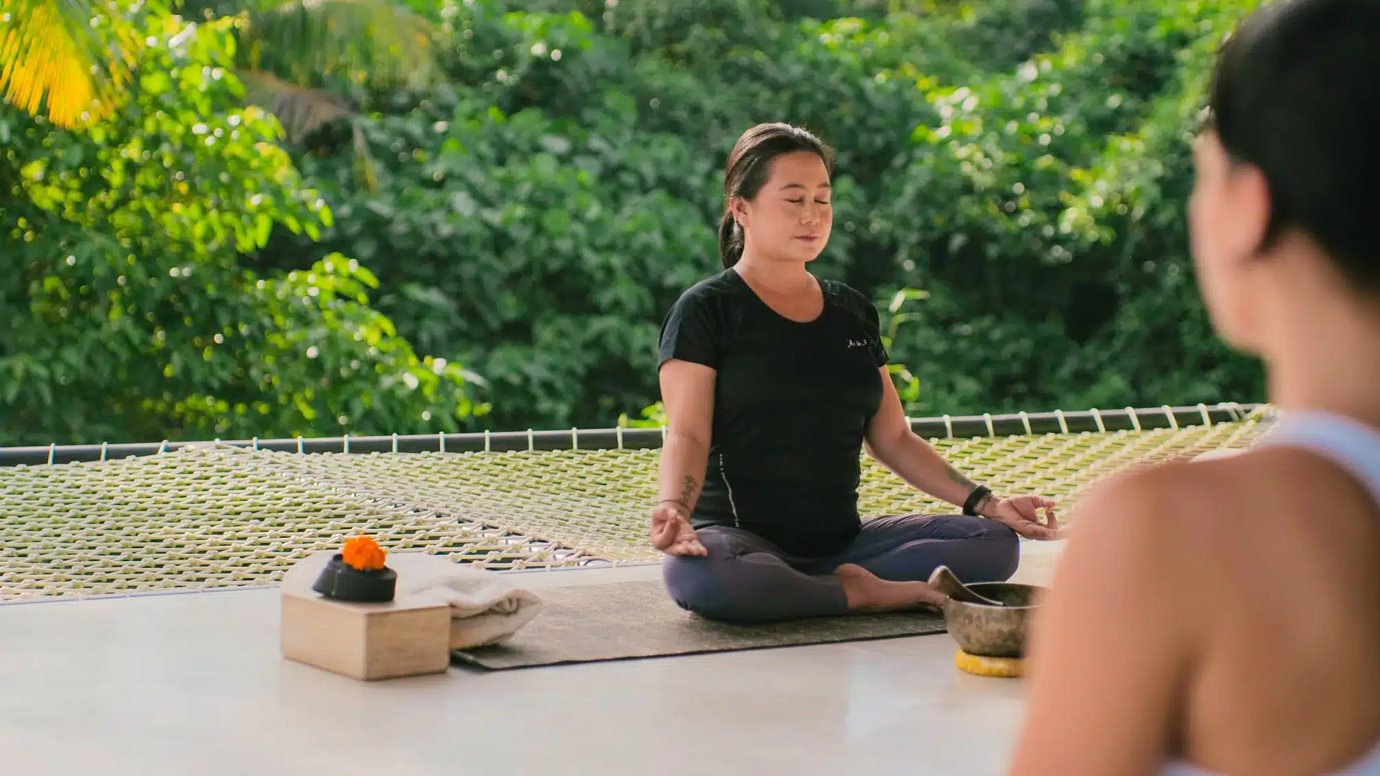 Solo female traveler meditating in a Bali yoga retreat Solo female traveler meditating in a Bali yoga retreat