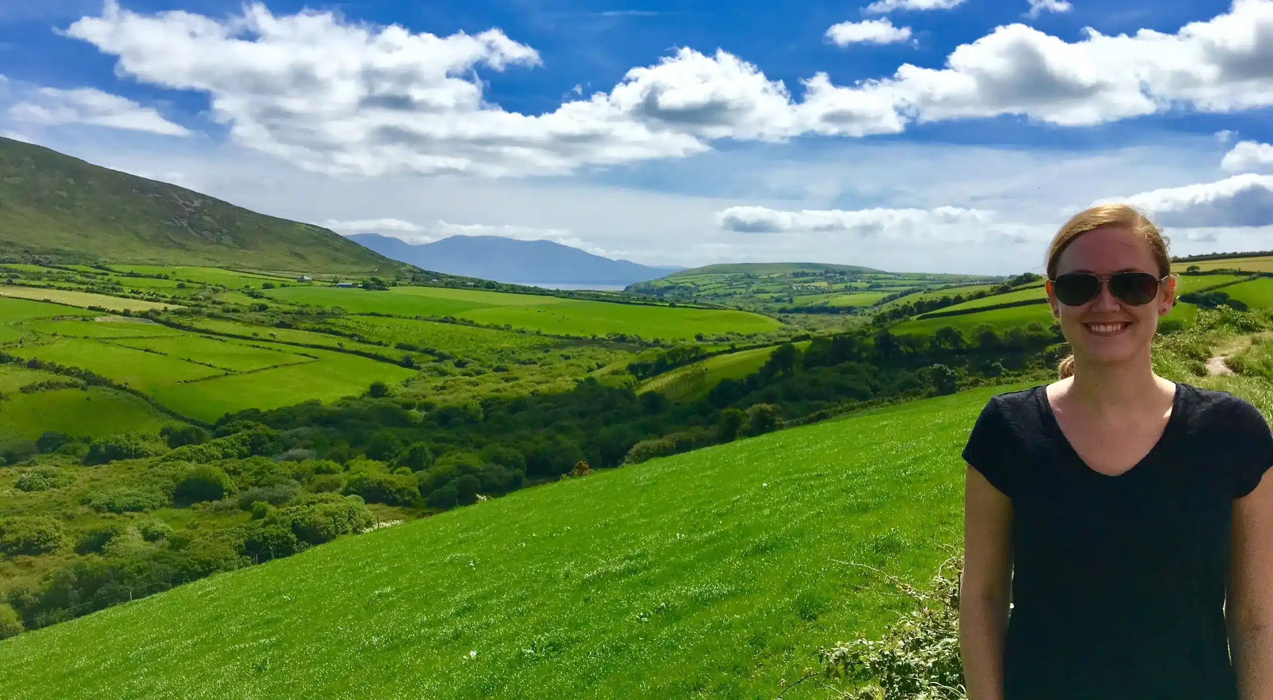 Woman exploring lush green hills in Ireland