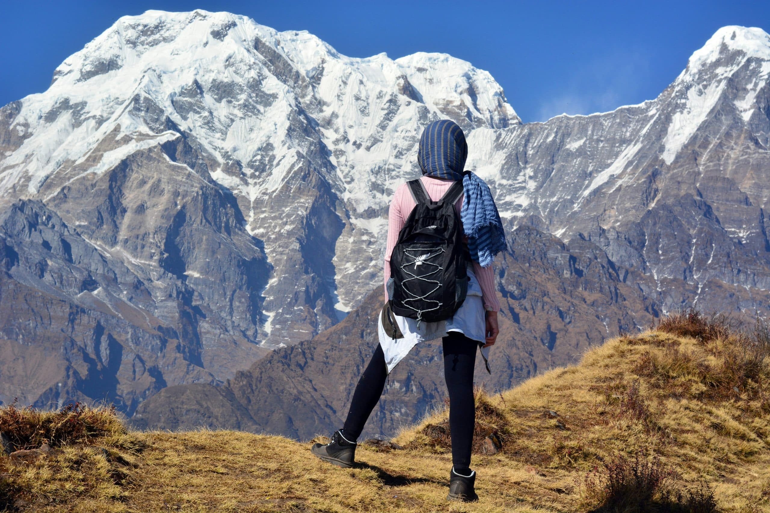 A solo female traveler overlooking a scenic viewpoint of New Zealand A solo female traveler overlooking a scenic viewpoint of New Zealand
