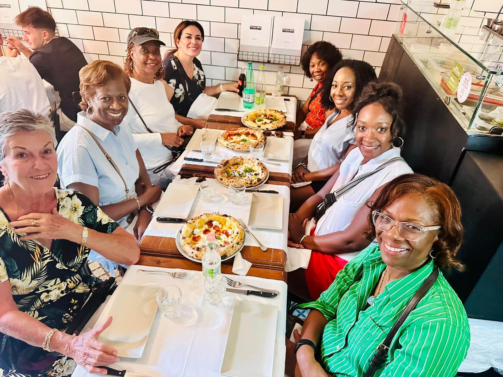 WTA travelers enjoying authentic, oven-fresh pizza in the heart of Italy WTA travelers enjoying authentic, oven-fresh pizza in the heart of Italy