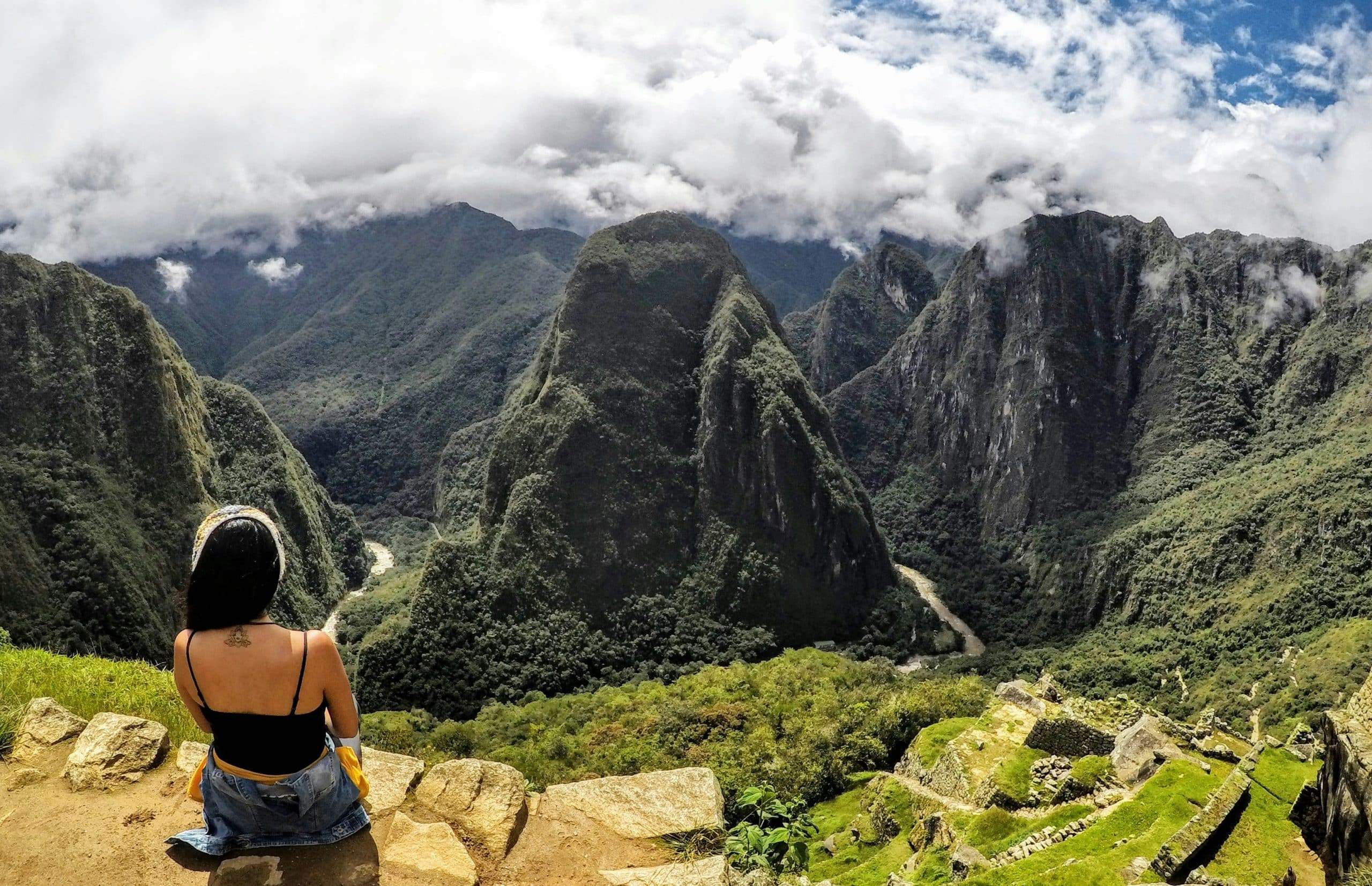 Solo female hiker exploring ancient Inca ruins in Peru on a sabbatical journey Solo female hiker exploring ancient Inca ruins in Peru on a sabbatical journey