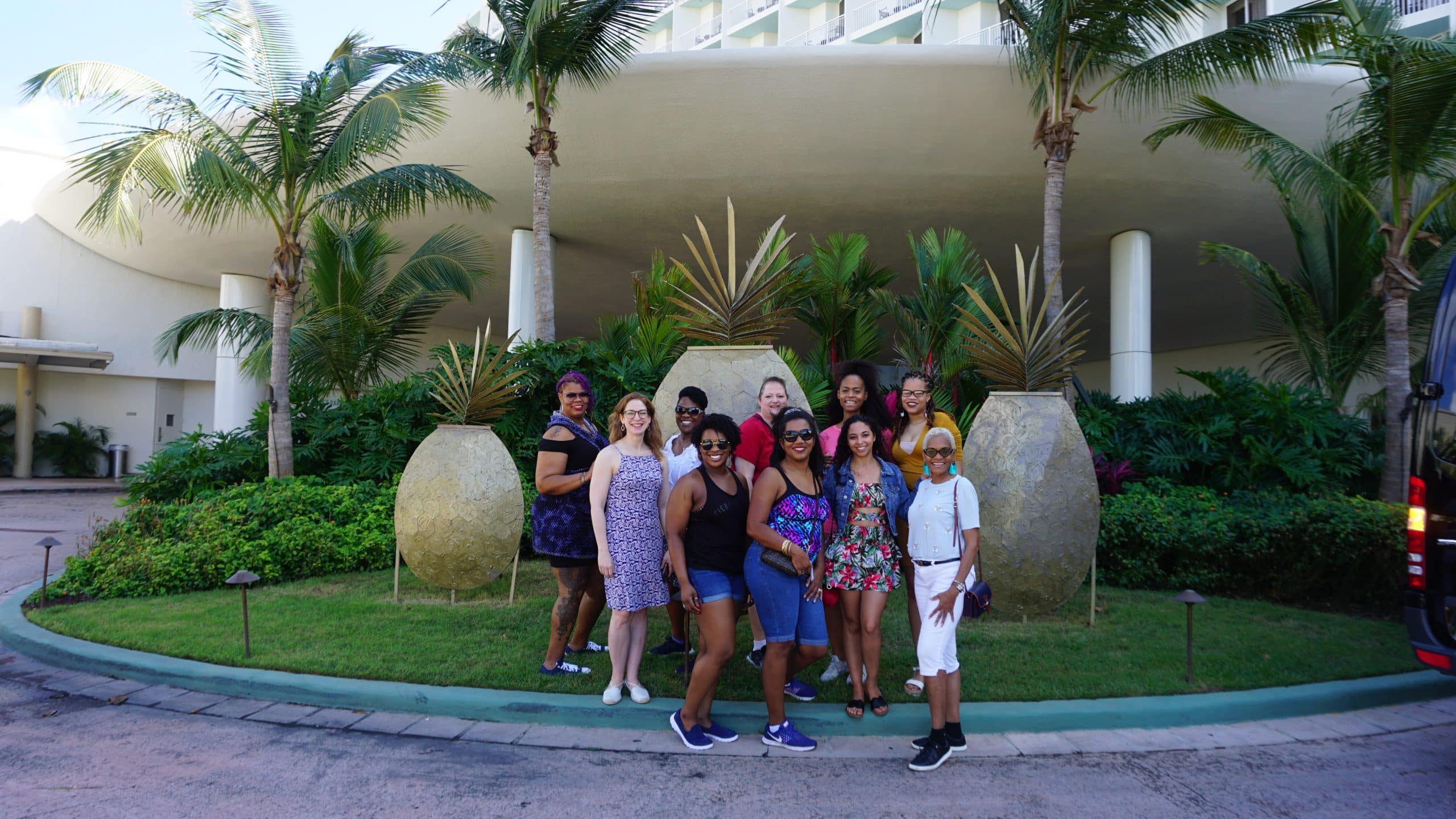 Women Travel Abroad group smiling together outside their hotel before exploring a new destination