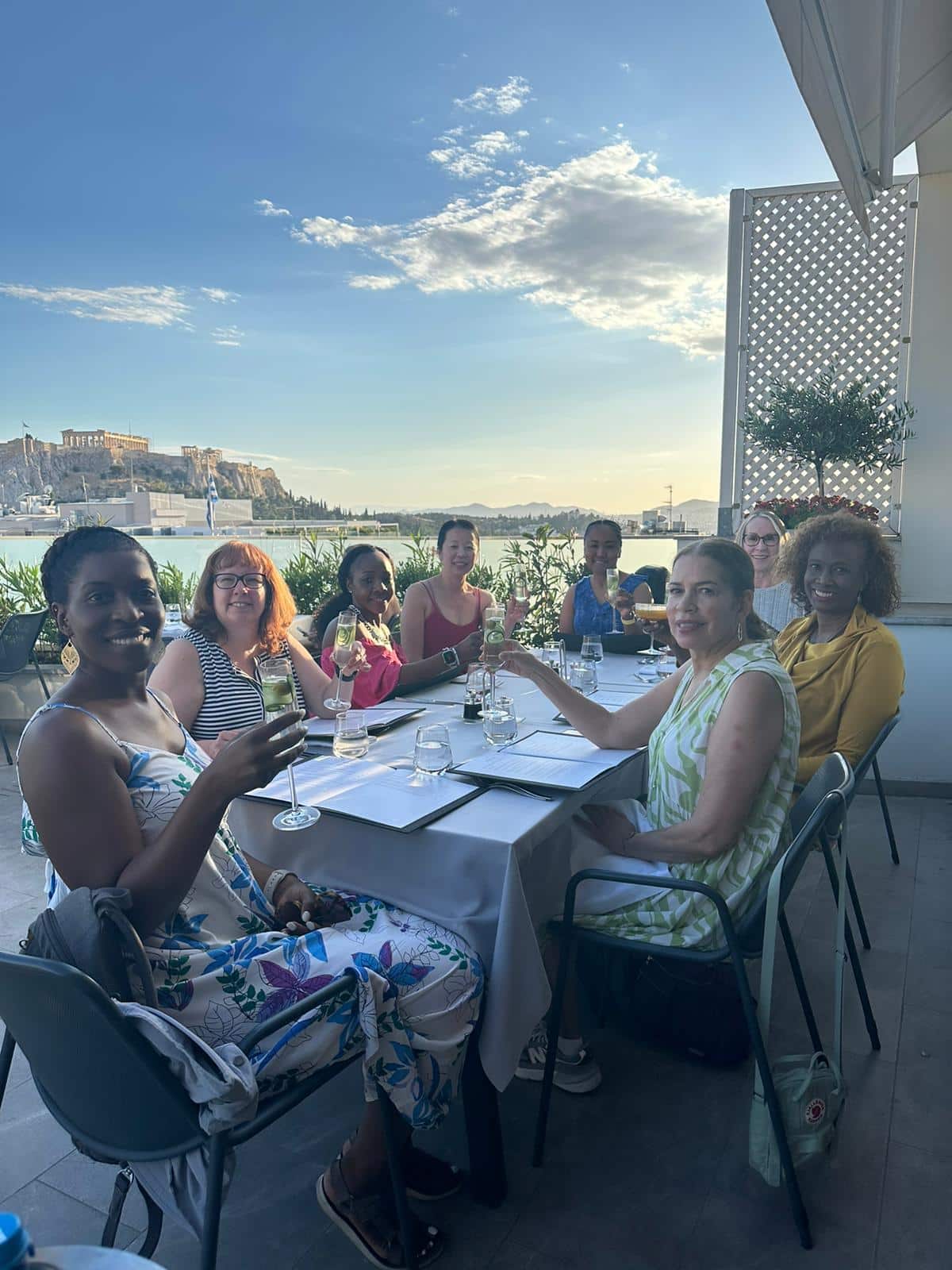 WTA traveler enjoying wine with a view of Santorini WTA traveler enjoying wine with a view of Santorini