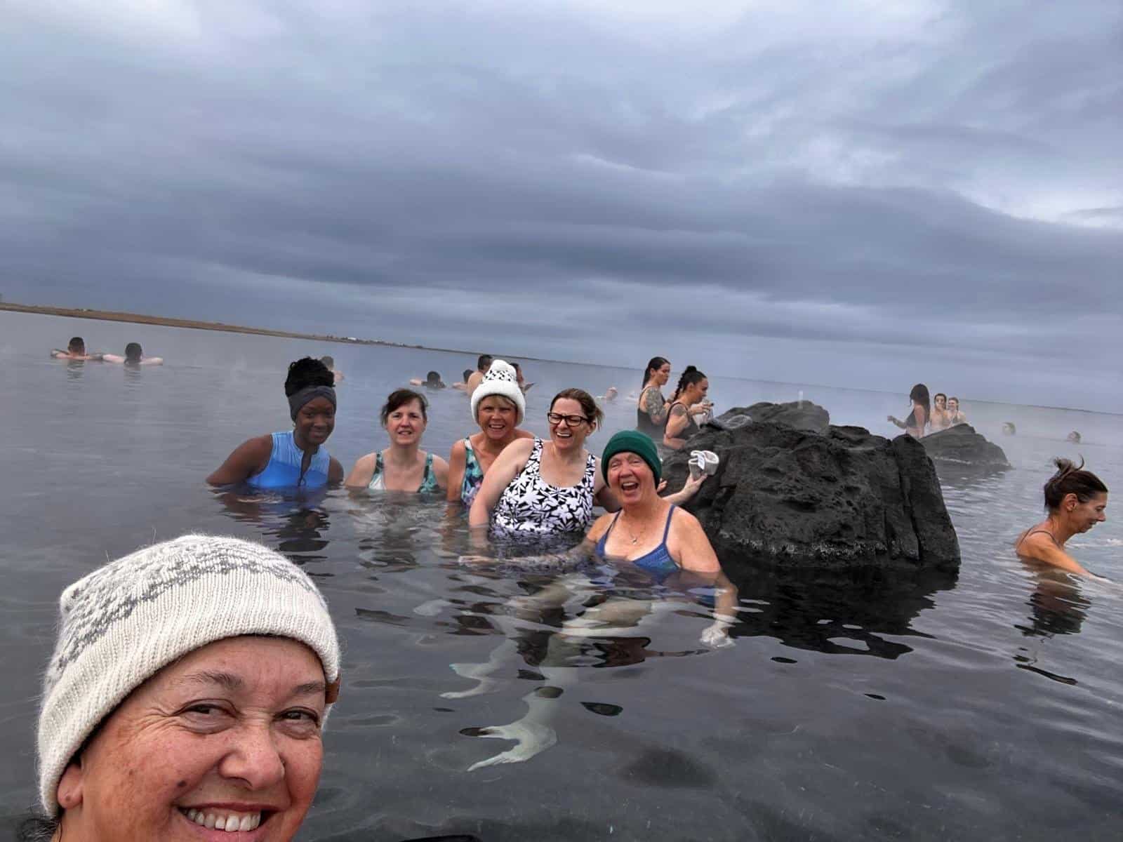 WTA travelers bonding in an Iceland hot spring under the Northern Lights WTA travelers bonding in an Iceland hot spring under the Northern Lights