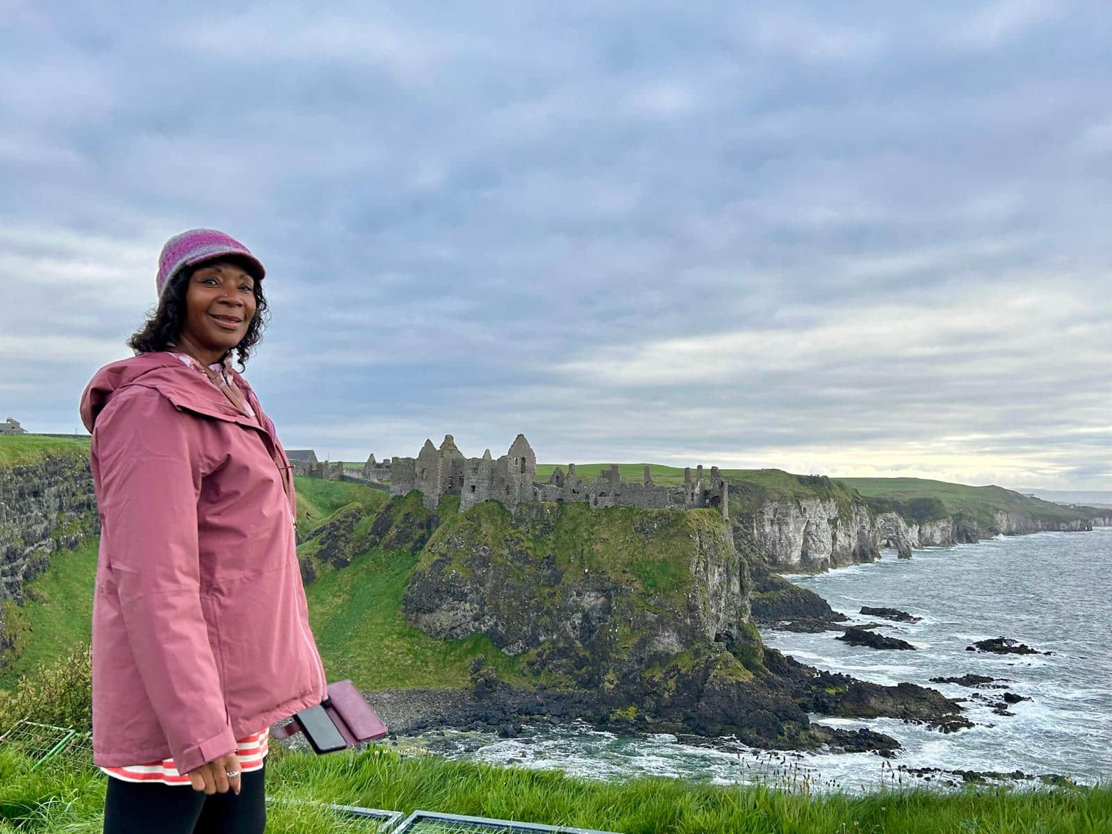 WTA traveler enjoying the dramatic views at the Cliffs of Moher, Ireland. WTA traveler enjoying the dramatic views at the Cliffs of Moher, Ireland.