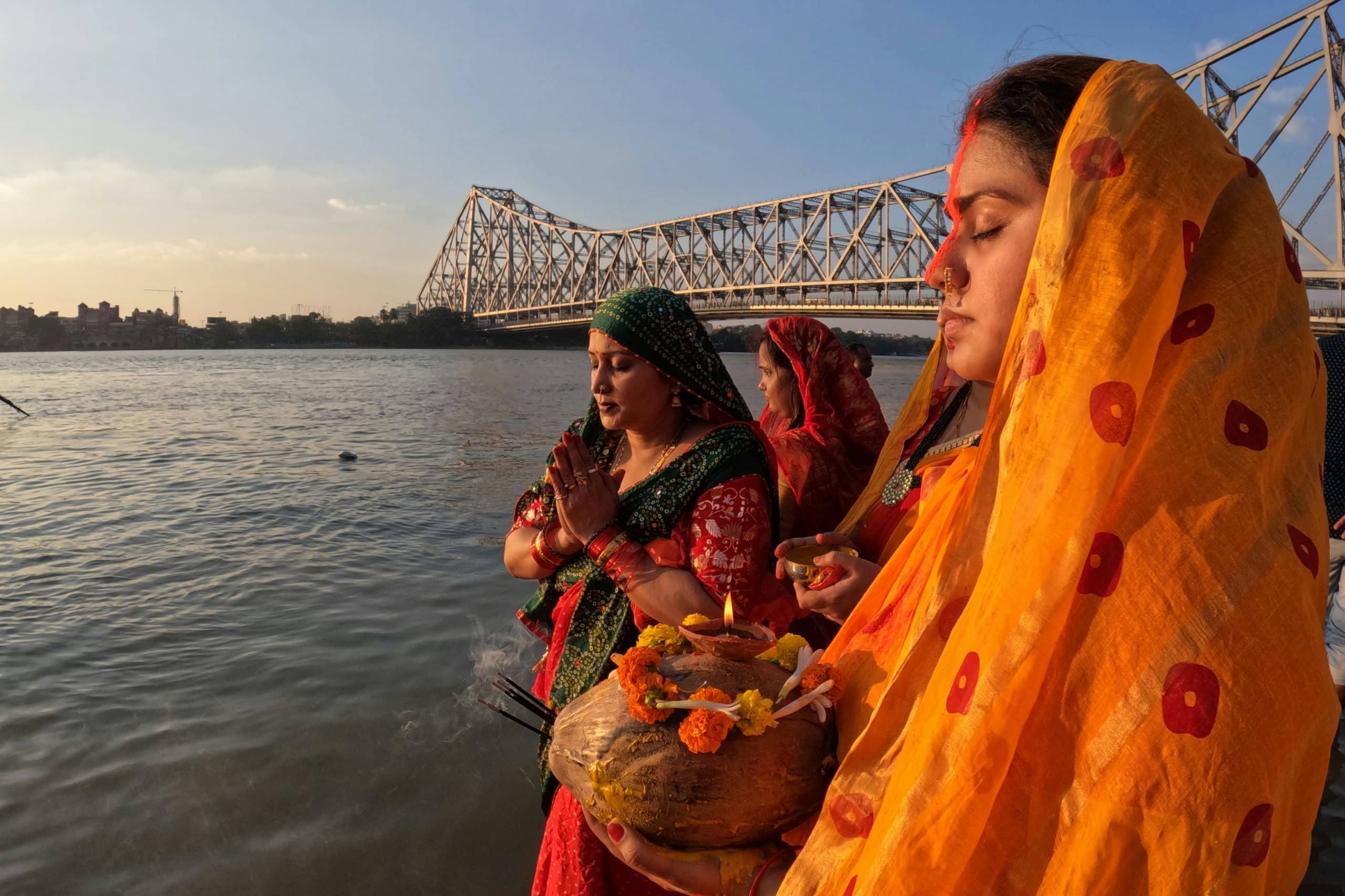 emale travelers meditating along the Ganges River in Rishikesh, India emale travelers meditating along the Ganges River in Rishikesh, India