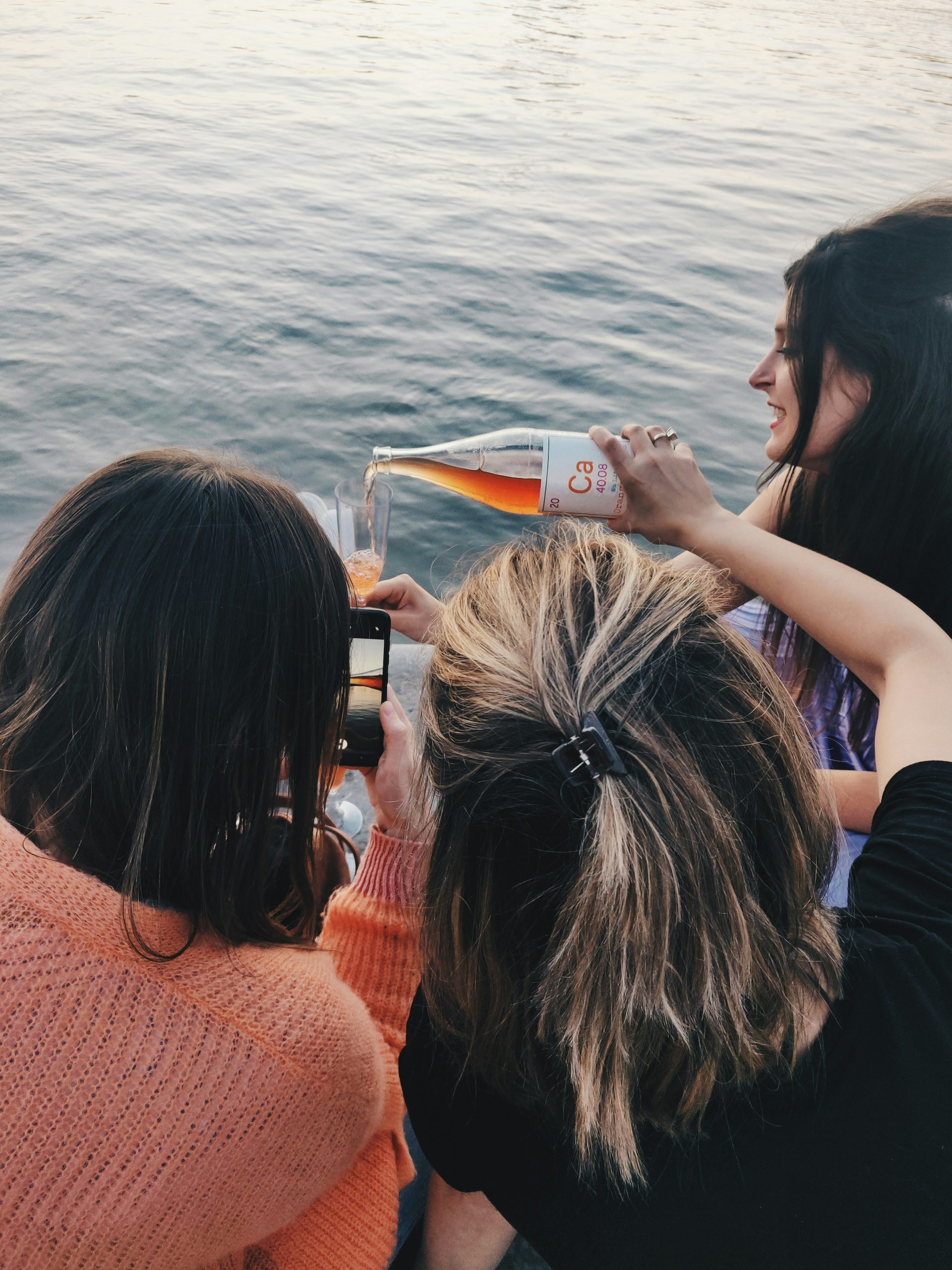 Group of solo female travelers smiling and clinking glasses at a wine tasting on a cruise ship Group of solo female travelers smiling and clinking glasses at a wine tasting on a cruise ship