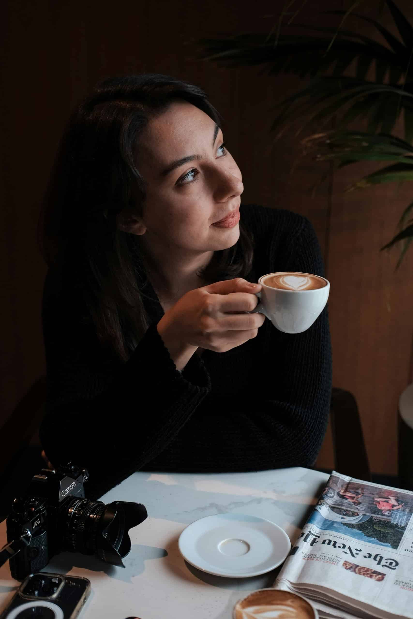 Female traveler at a café, looking relaxed and reflective Female traveler at a café, looking relaxed and reflective