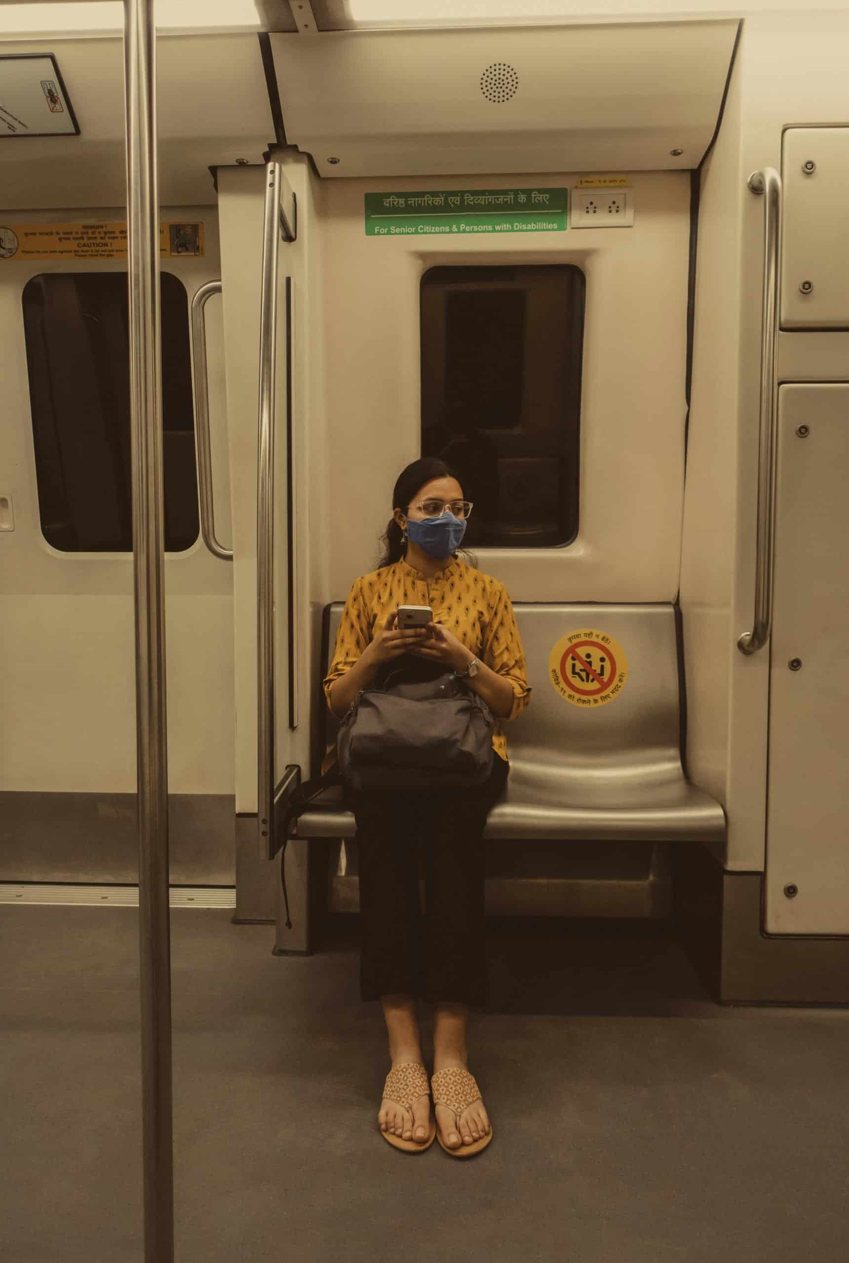 Female traveler using navigation app in an international subway station Female traveler using navigation app in an international subway station