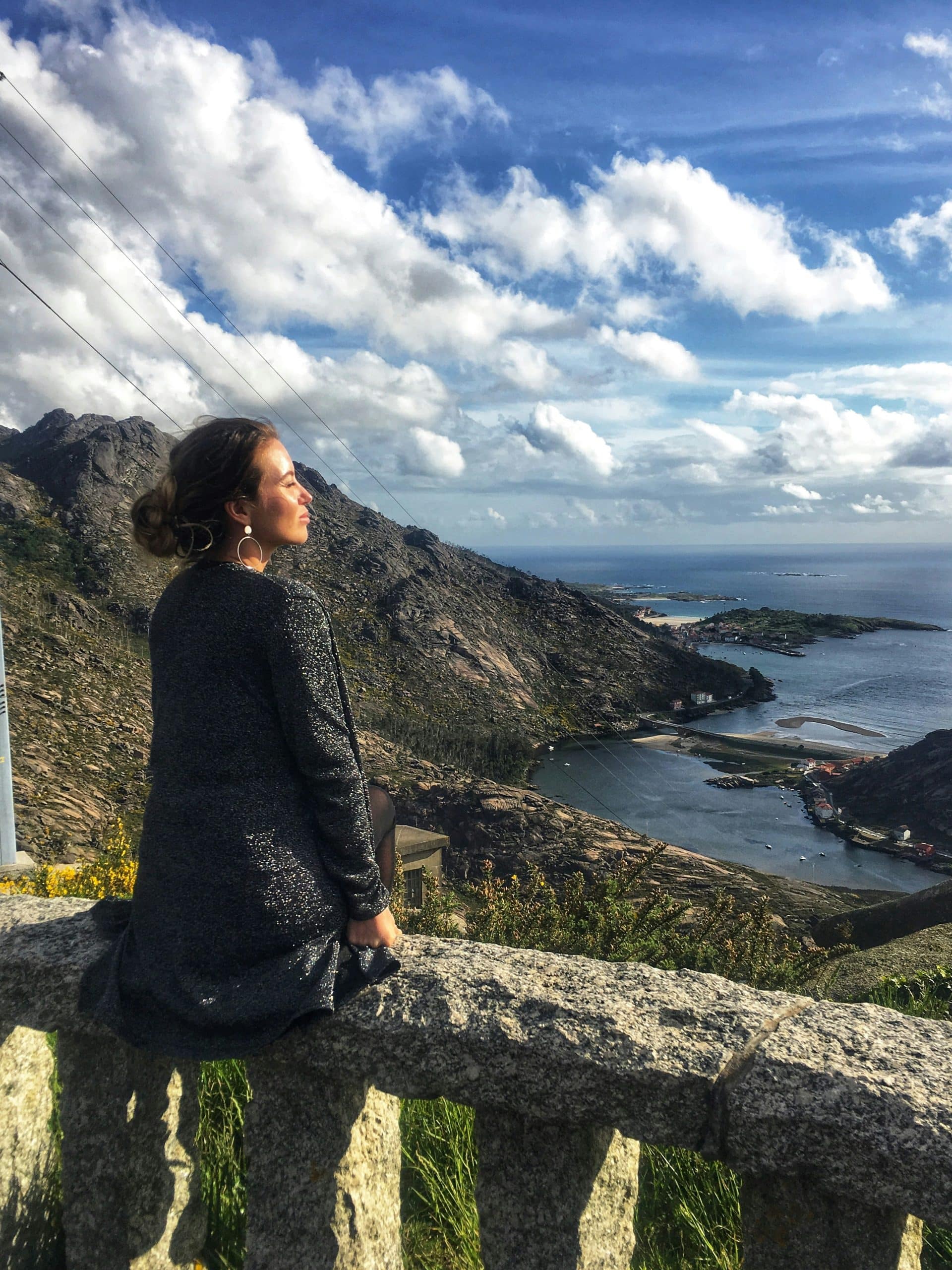 Solo female traveler journaling on a scenic overlook during her career sabbatical Solo female traveler journaling on a scenic overlook during her career sabbatical