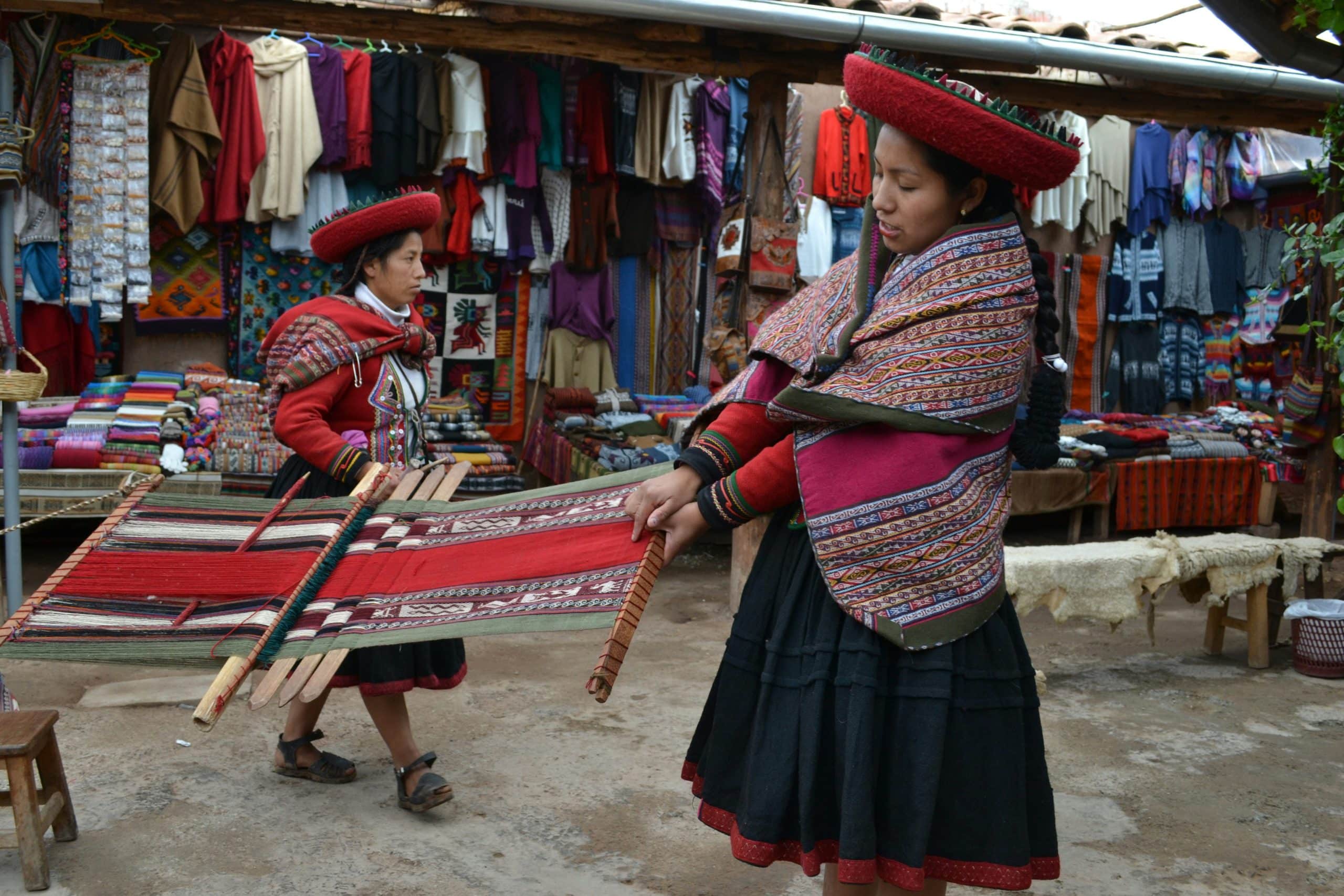 Quechua women weaving traditional textiles in bright Andean clothing Quechua women weaving traditional textiles in bright Andean clothing