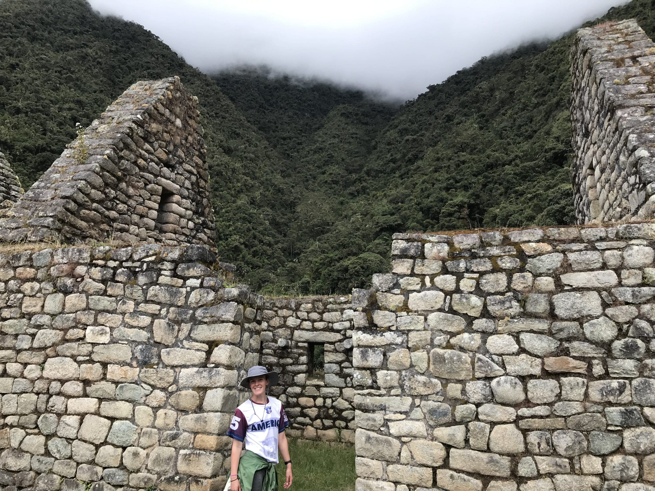 WTA-Women traveler with a view of Ancient Inca stonework that meets the Peruvian clouds. WTA-Women traveler with a view of Ancient Inca stonework that meets the Peruvian clouds.
