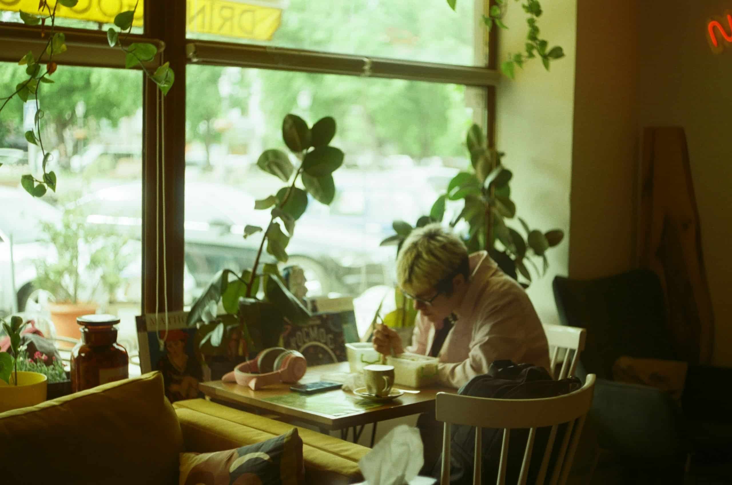 solo women journaling in a cafe solo women journaling in a cafe