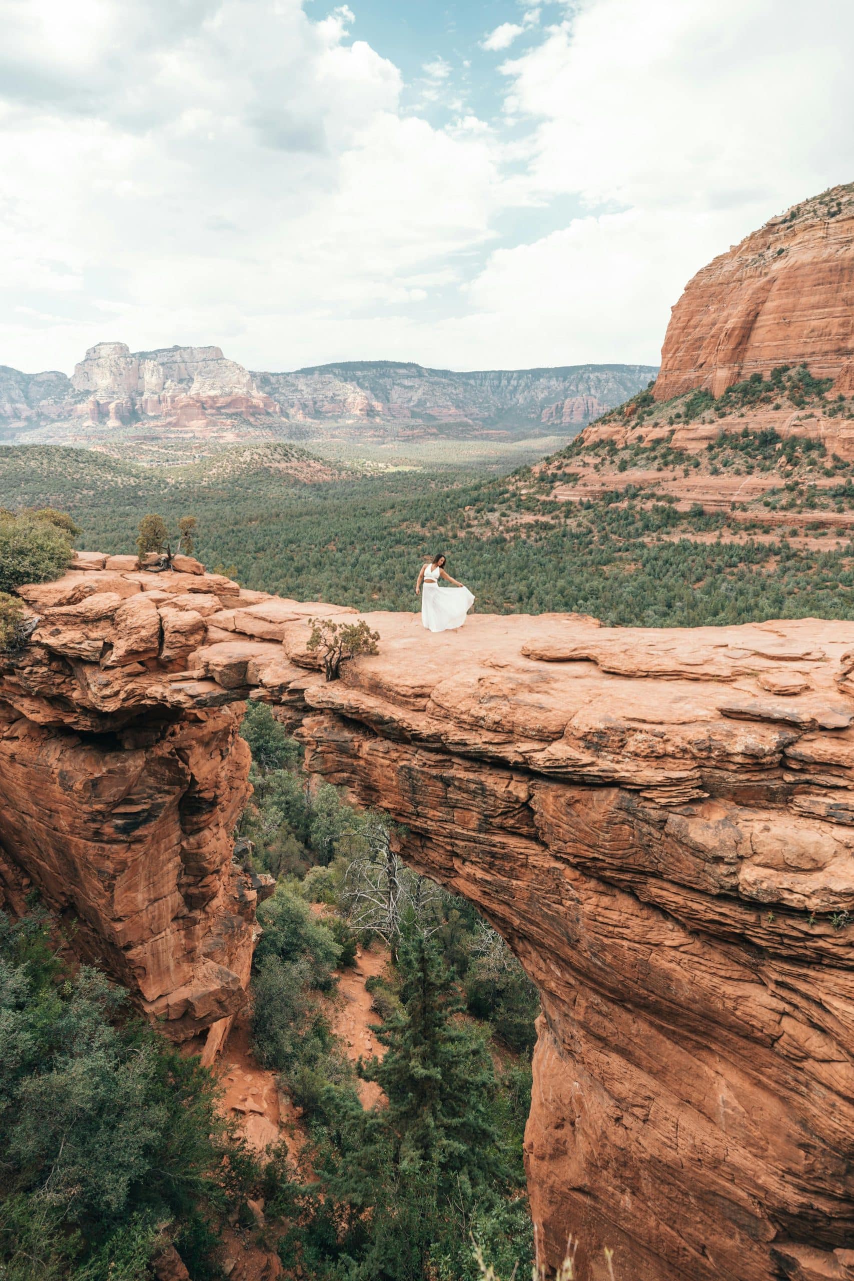 Woman in White Dress Posing on Rock Formation in Sedona Woman in White Dress Posing on Rock Formation in Sedona