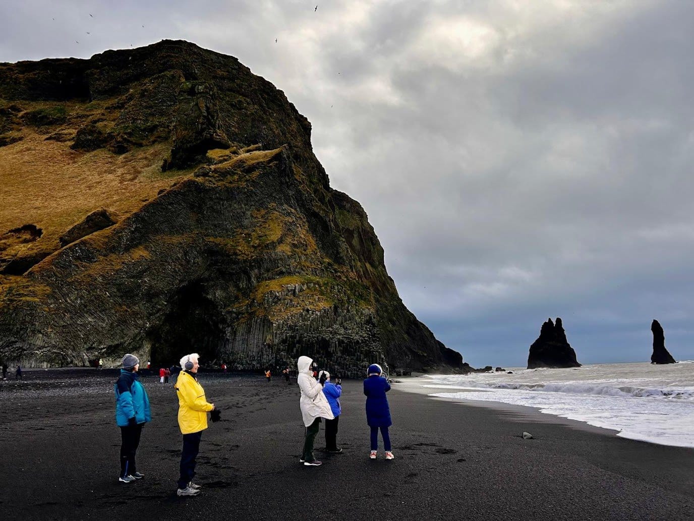 Women Travel Abroad travelers admiring the black sand beaches of Iceland
