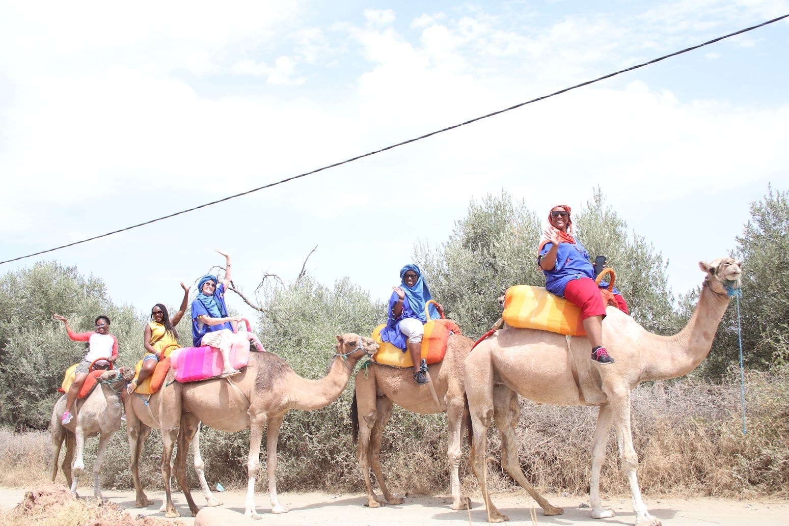 Women riding camels in Morocco