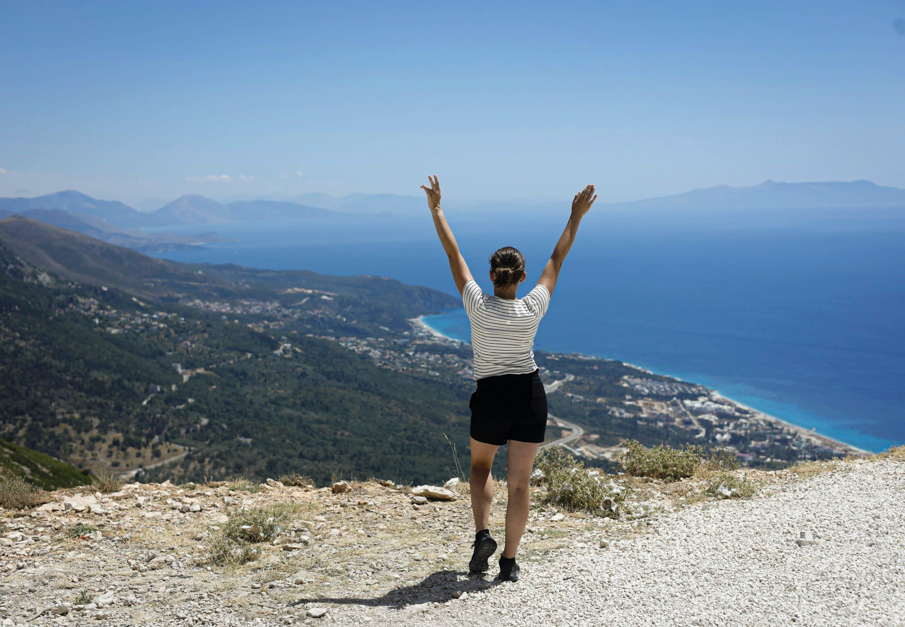 A woman reaching the top of Himarë, Albania